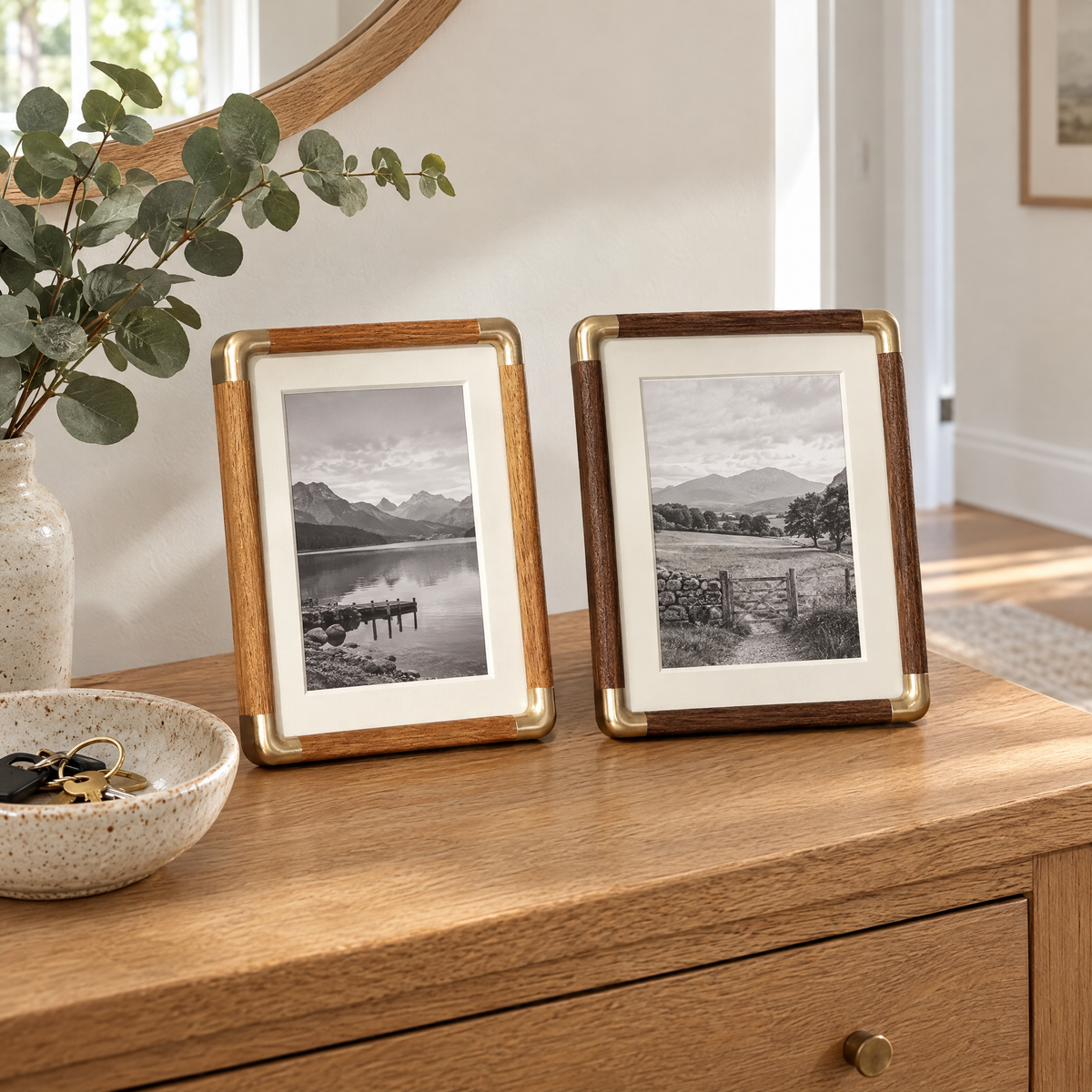 Teak and walnut Cornice photo frames on an oak console in a hallway