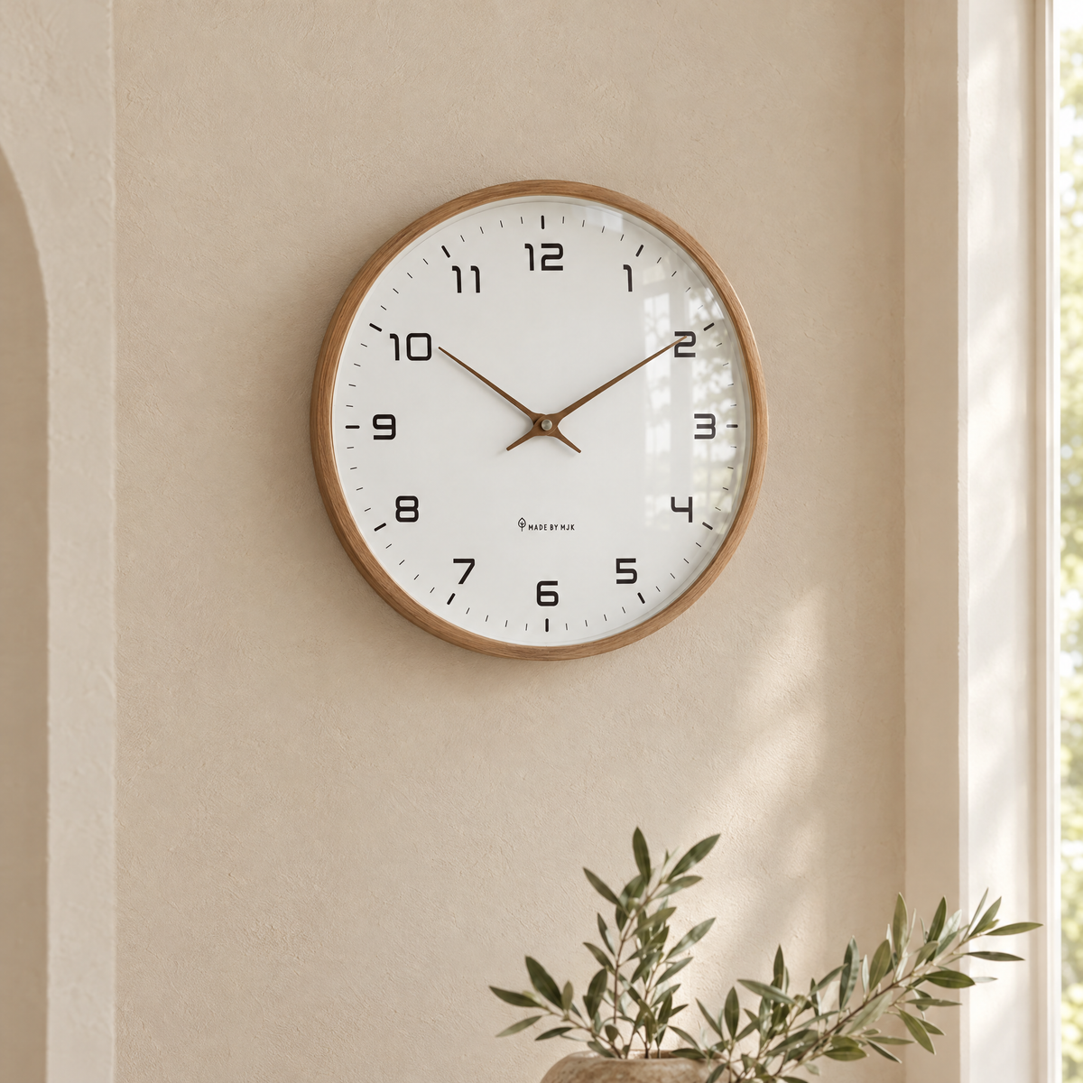 Close-up of the brown wood frame and white dial of the Ora clock