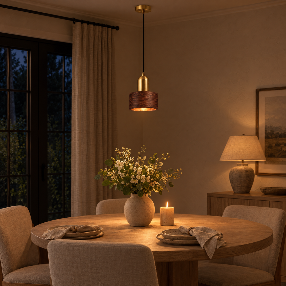 Noce Walnut Cylinder Pendant Light glowing over a dinner table in the evening