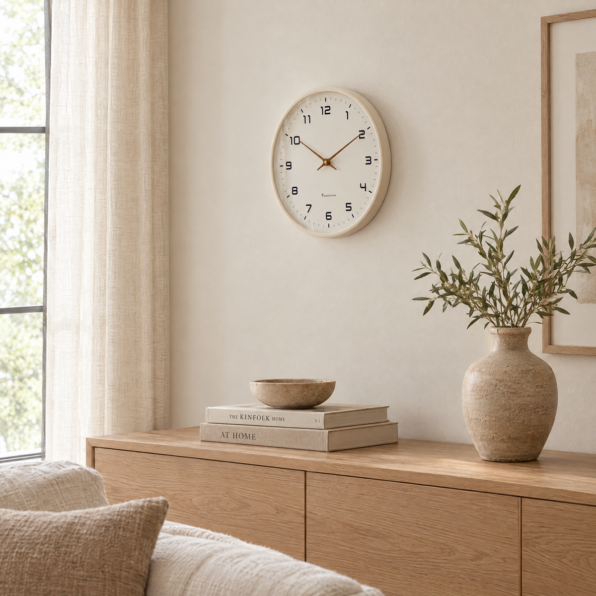 Ora wall clock in creme above an oak sideboard in a living room