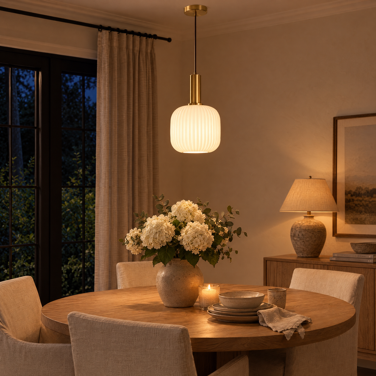 Rigata Ribbed Glass Ceiling Light glowing over a dining table in the evening