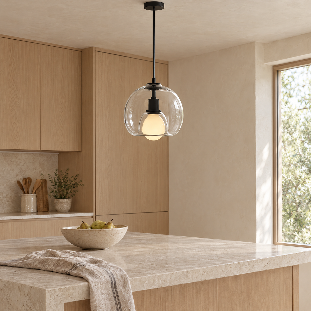 Vetro Glass Globe Pendant Light in clear glass above a stone kitchen island