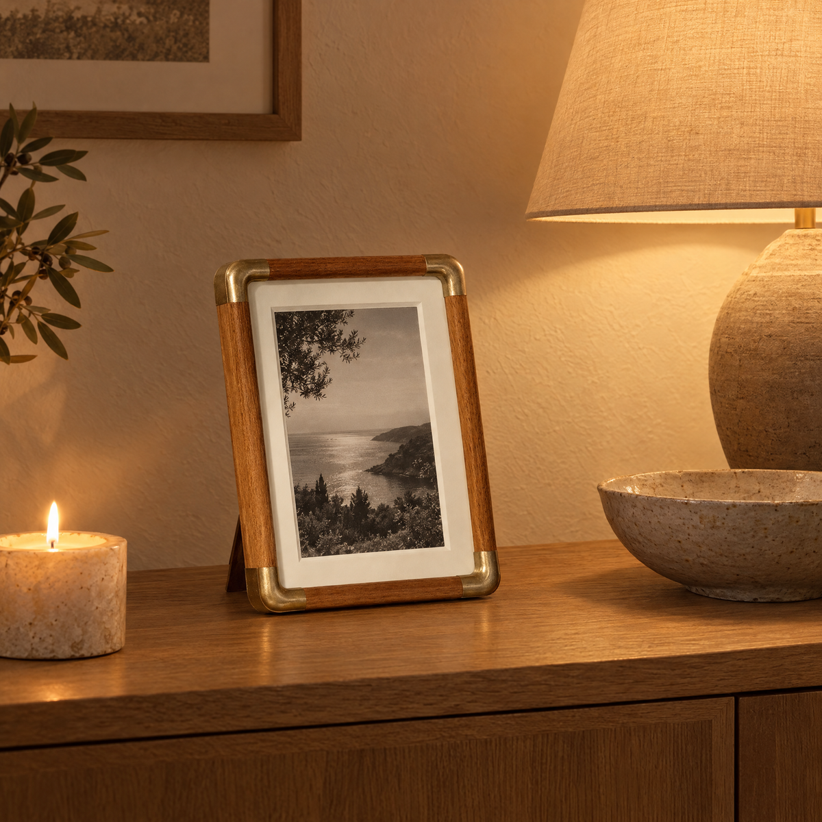 Teak Cornice photo frame on a lamp-lit console in the evening