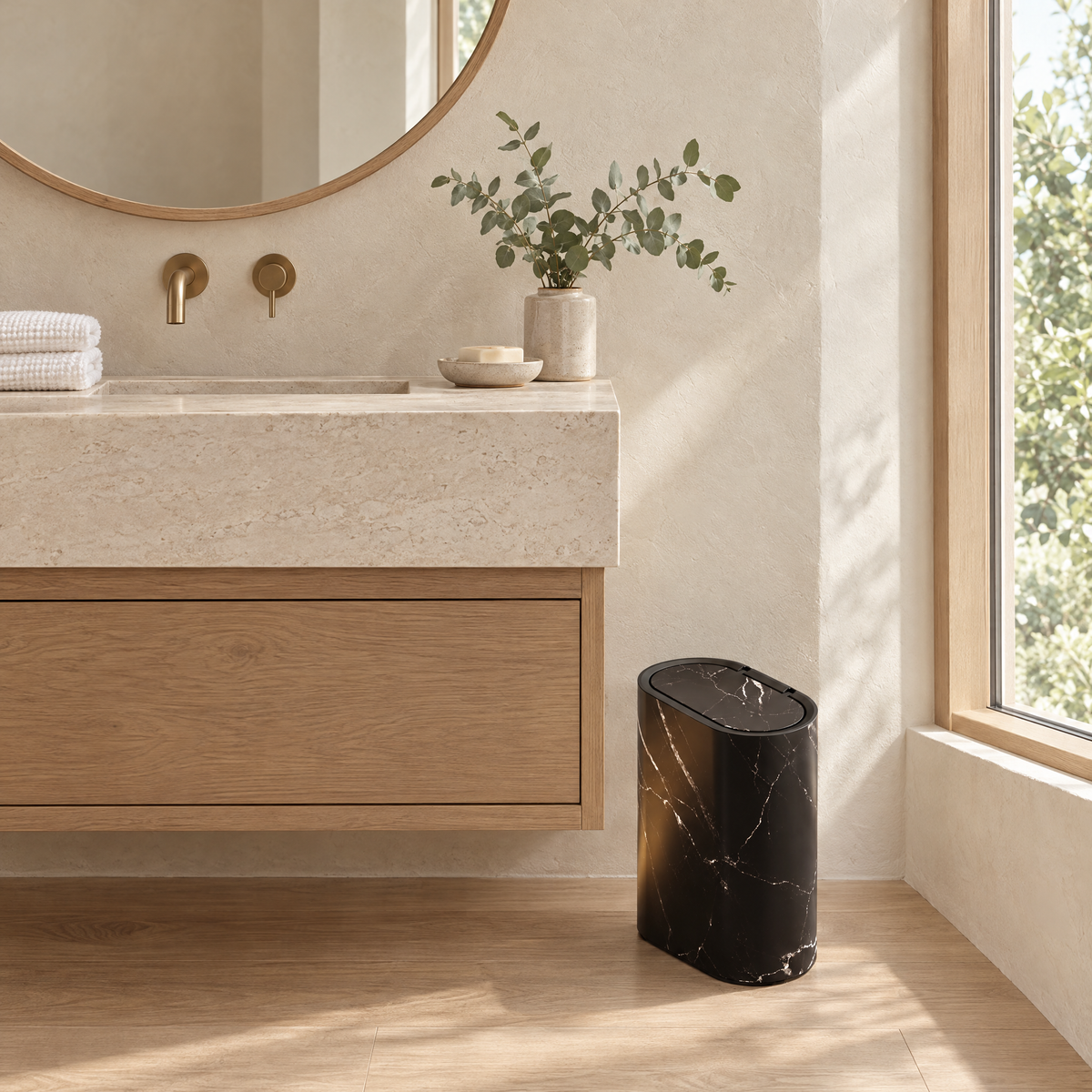 Black marble Pulito bin beside a stone vanity in a calm bathroom