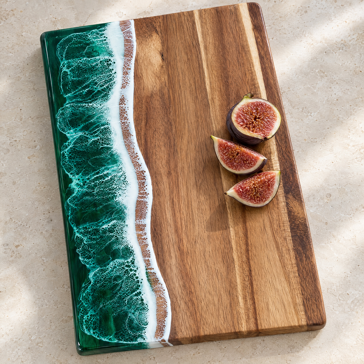 Close-up of the green resin wave and acacia grain on the Onda board