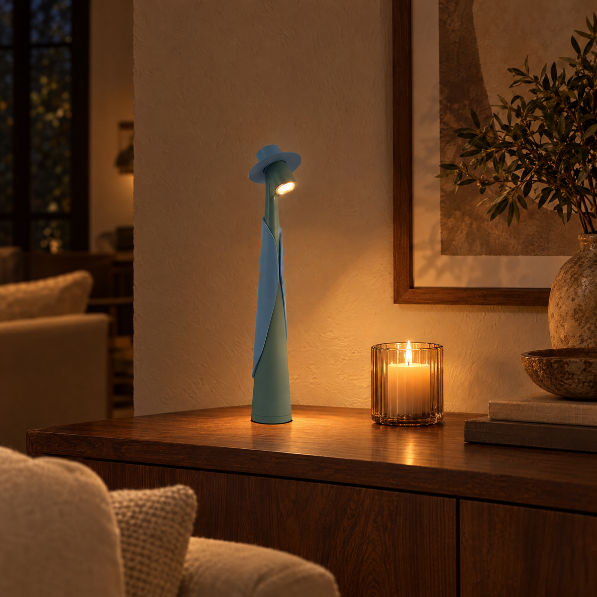 Teal Cappello lamp glowing in a living room in the evening