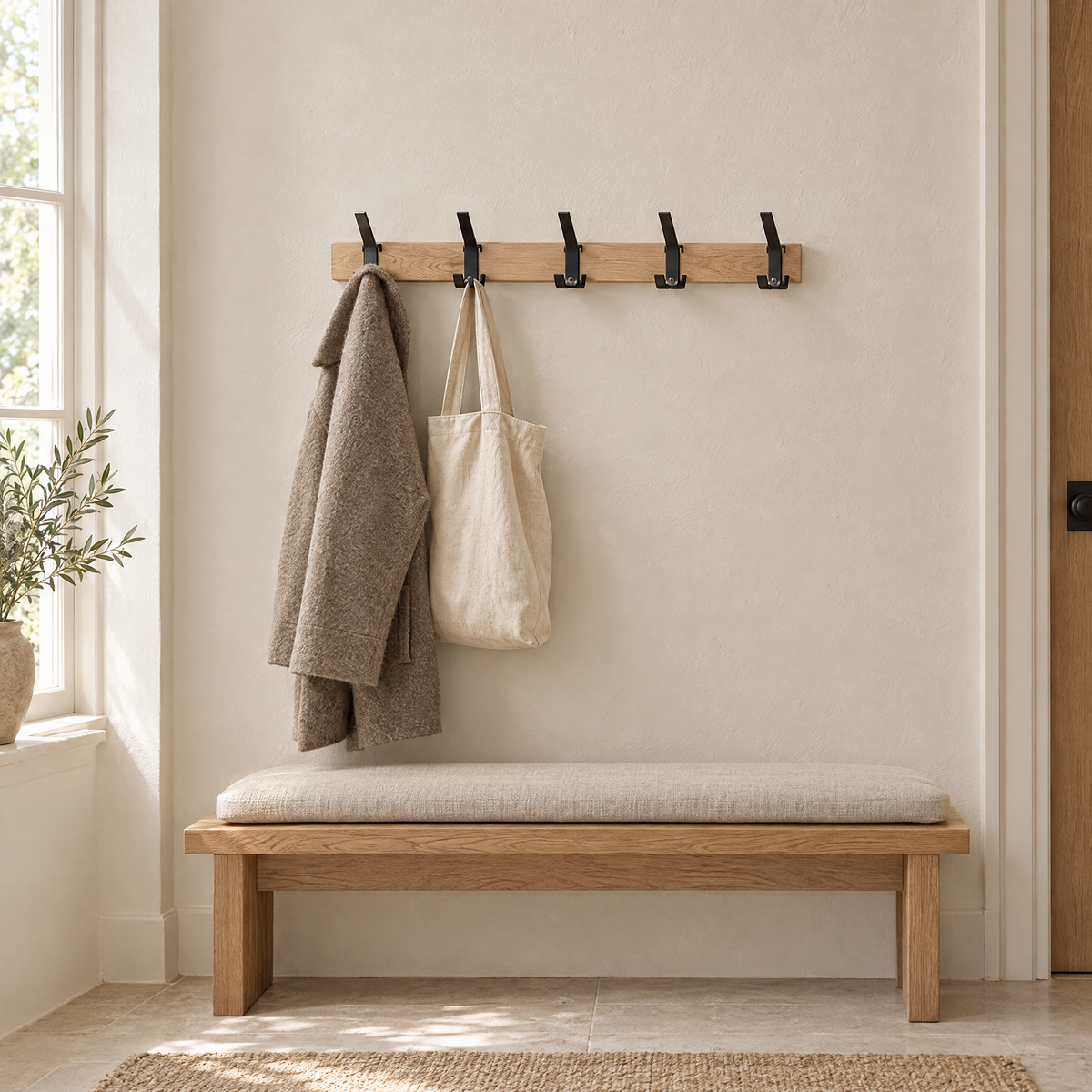 Gancio coat rack above an oak bench in a calm entry hall