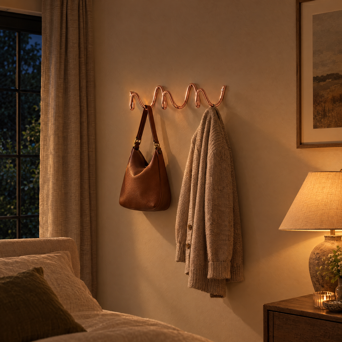 Flutto Wave Wall Hook Rack in rose gold in a bedroom in the evening