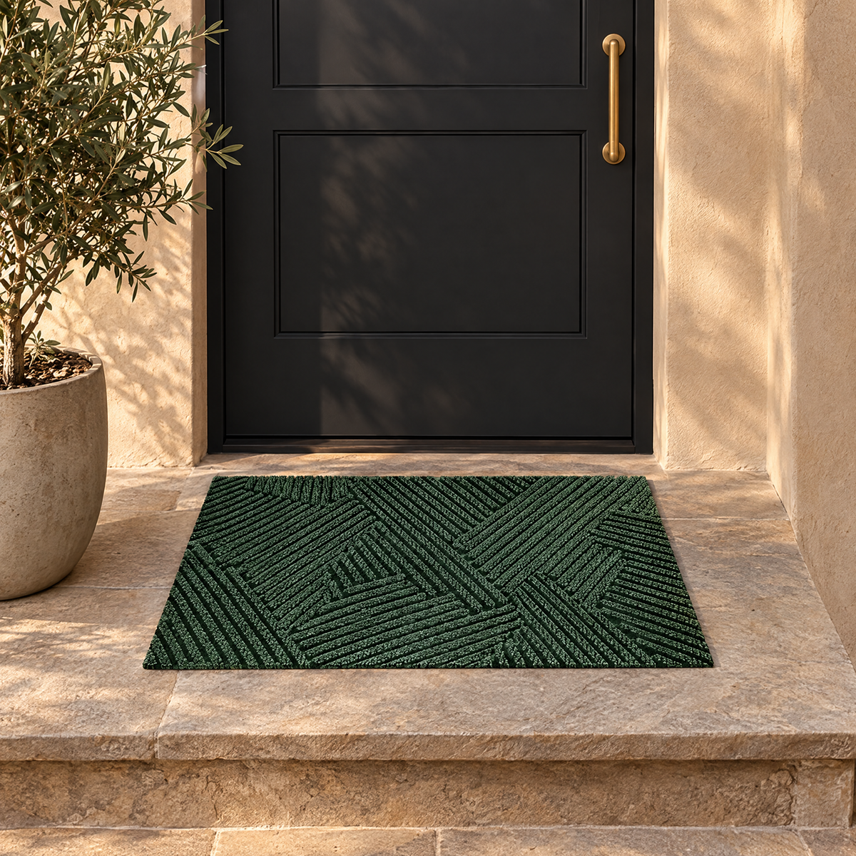 Linnea door mat on a stone step in front of a dark front door