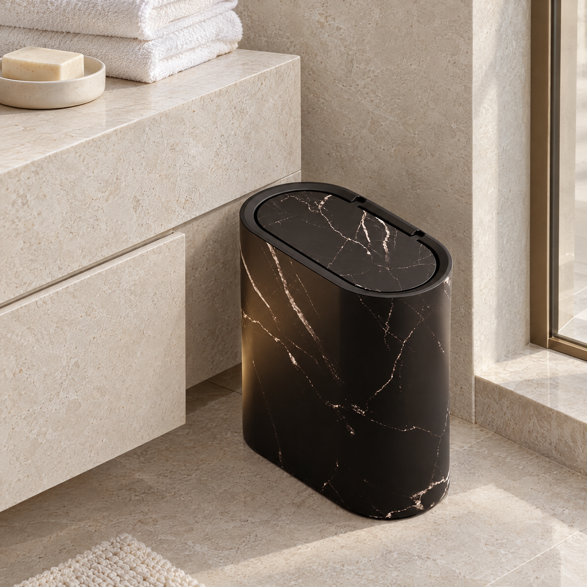 Black marble-look Pulito waste bin beside a stone bathroom vanity