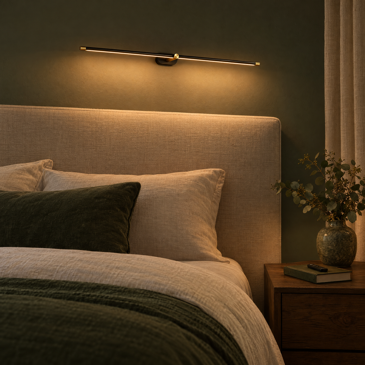 Quadro linear wall light above a headboard at night