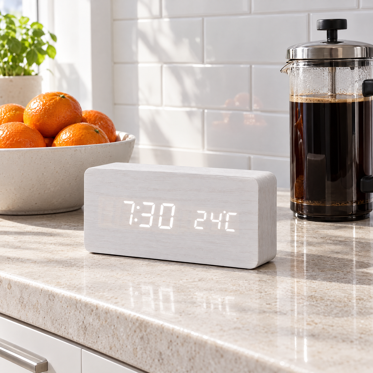 White Sveglia LED alarm clock on a stone kitchen counter